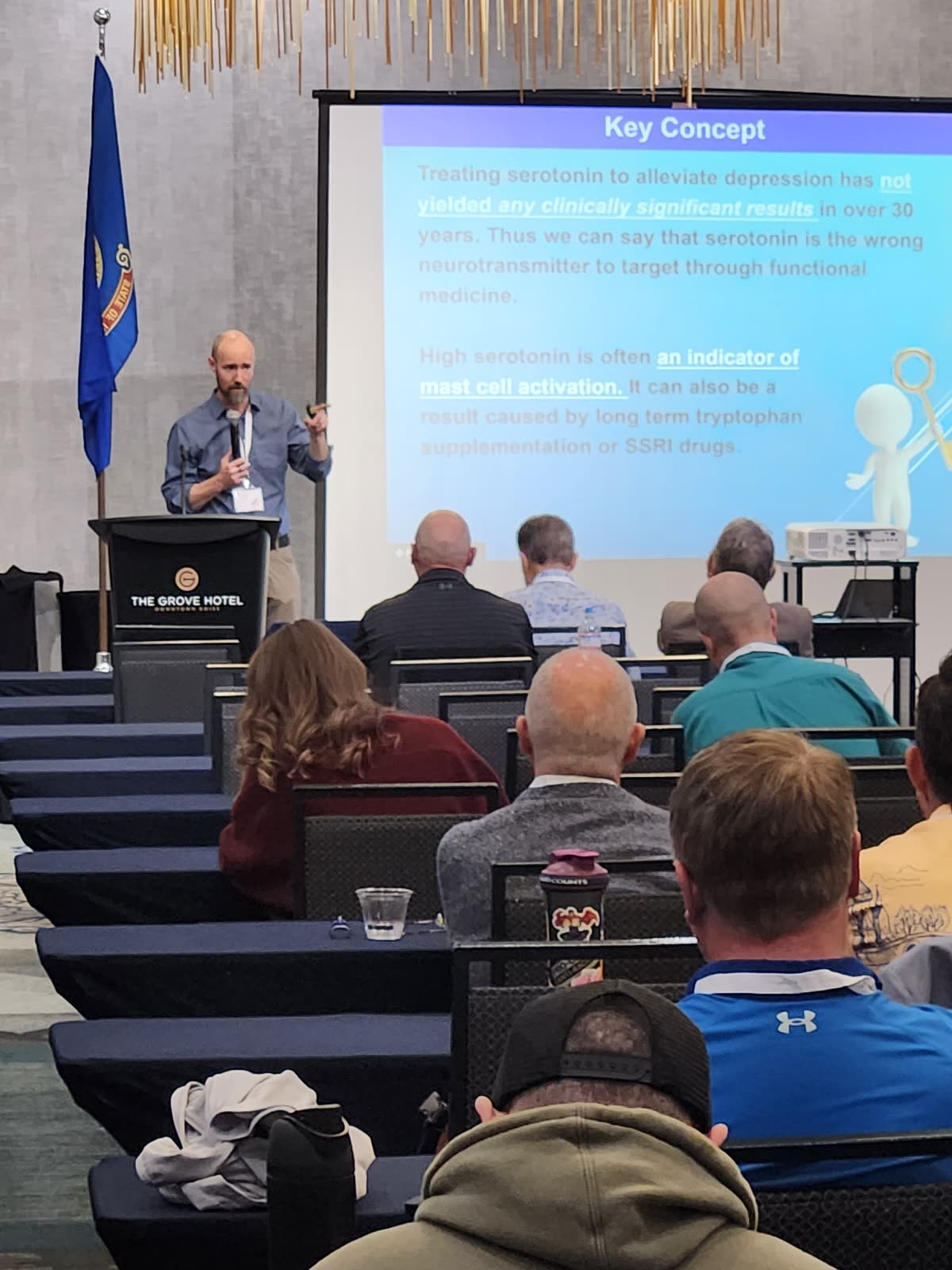 Dr. Rostenberg presenting at the Idaho Chiropractic Association — slide visible: serotonin and mast cell activation — The Grove Hotel, Boise